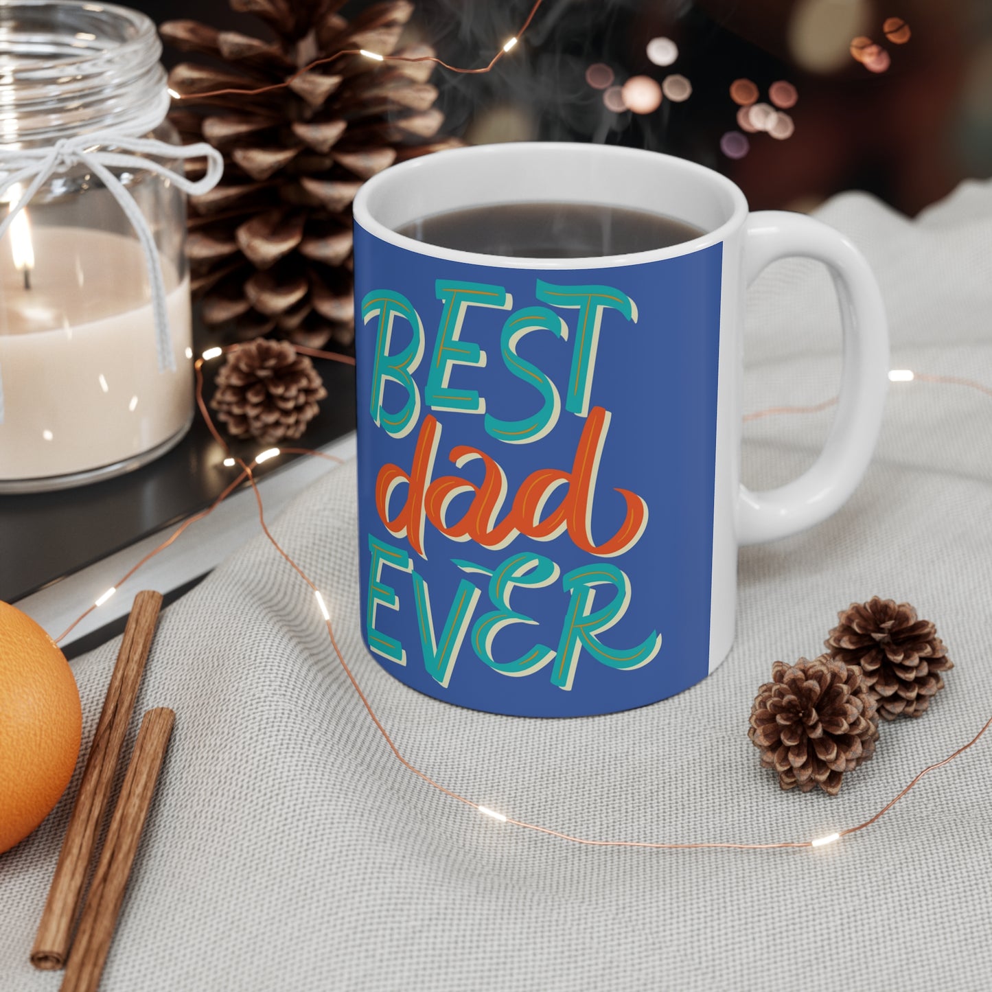 “BEST DAD EVER” on one side and dad reading to his baby. Part of several mugs to choose from depending on what resonates with you.