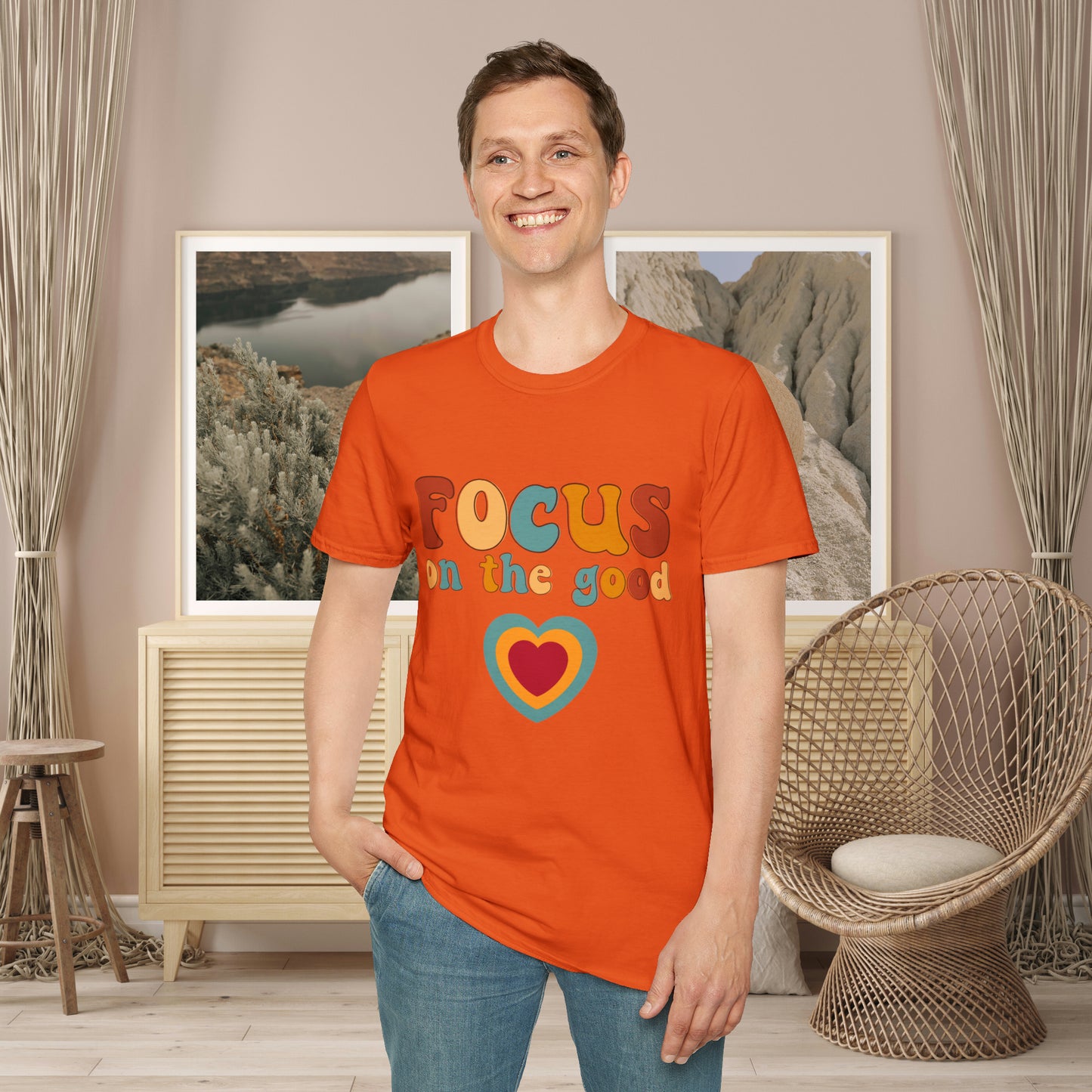 “FOCUS on the good” above a multicolored heart on this Unisex Softstyle T-Shirt.