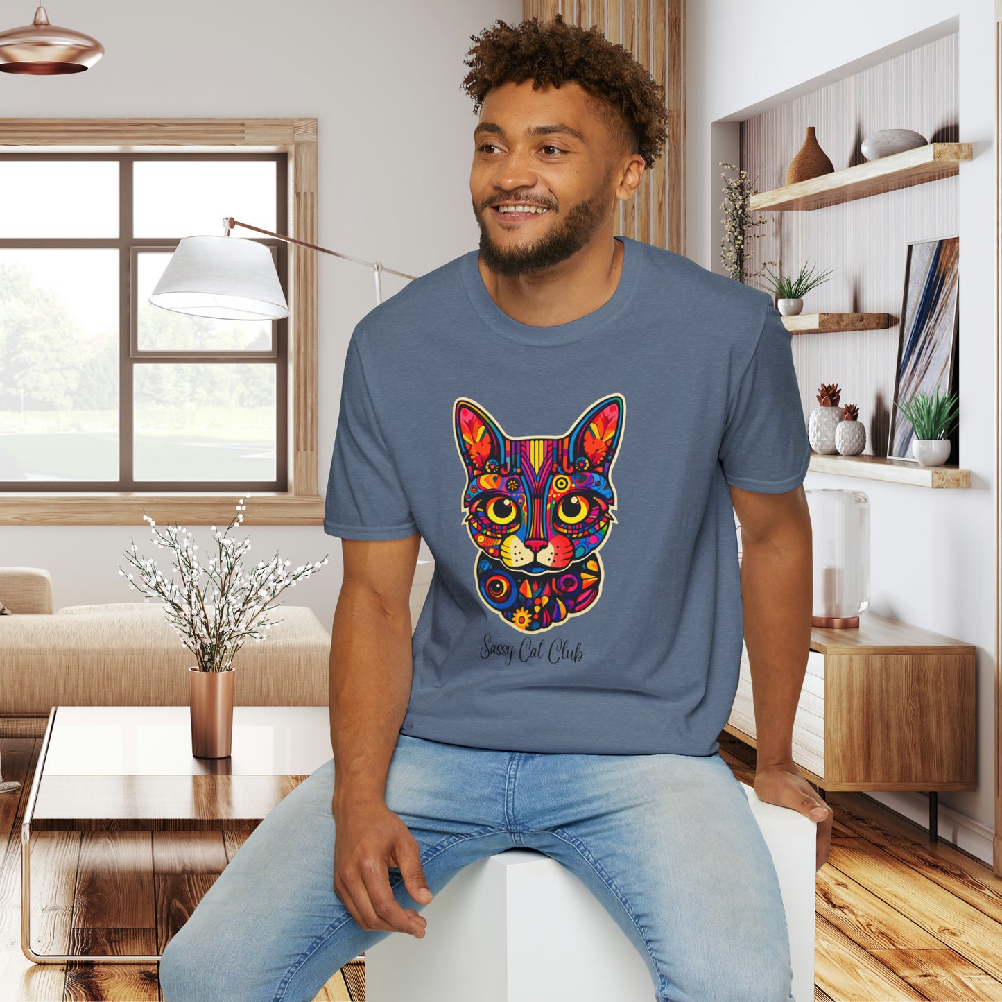A mesmerizing cat that just pulls you to look into its eyes with “Sassy Cat Club” below it on this Unisex Softstyle T-Shirt.