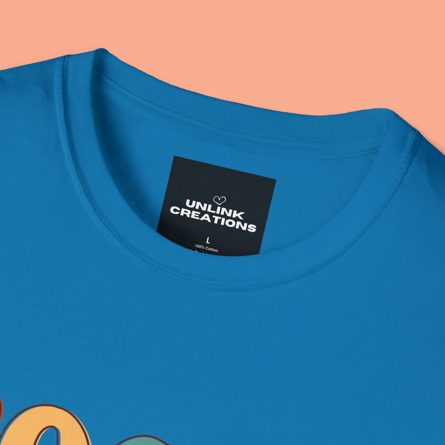 “FOCUS on the good” above a multicolored heart on this Unisex Softstyle T-Shirt.