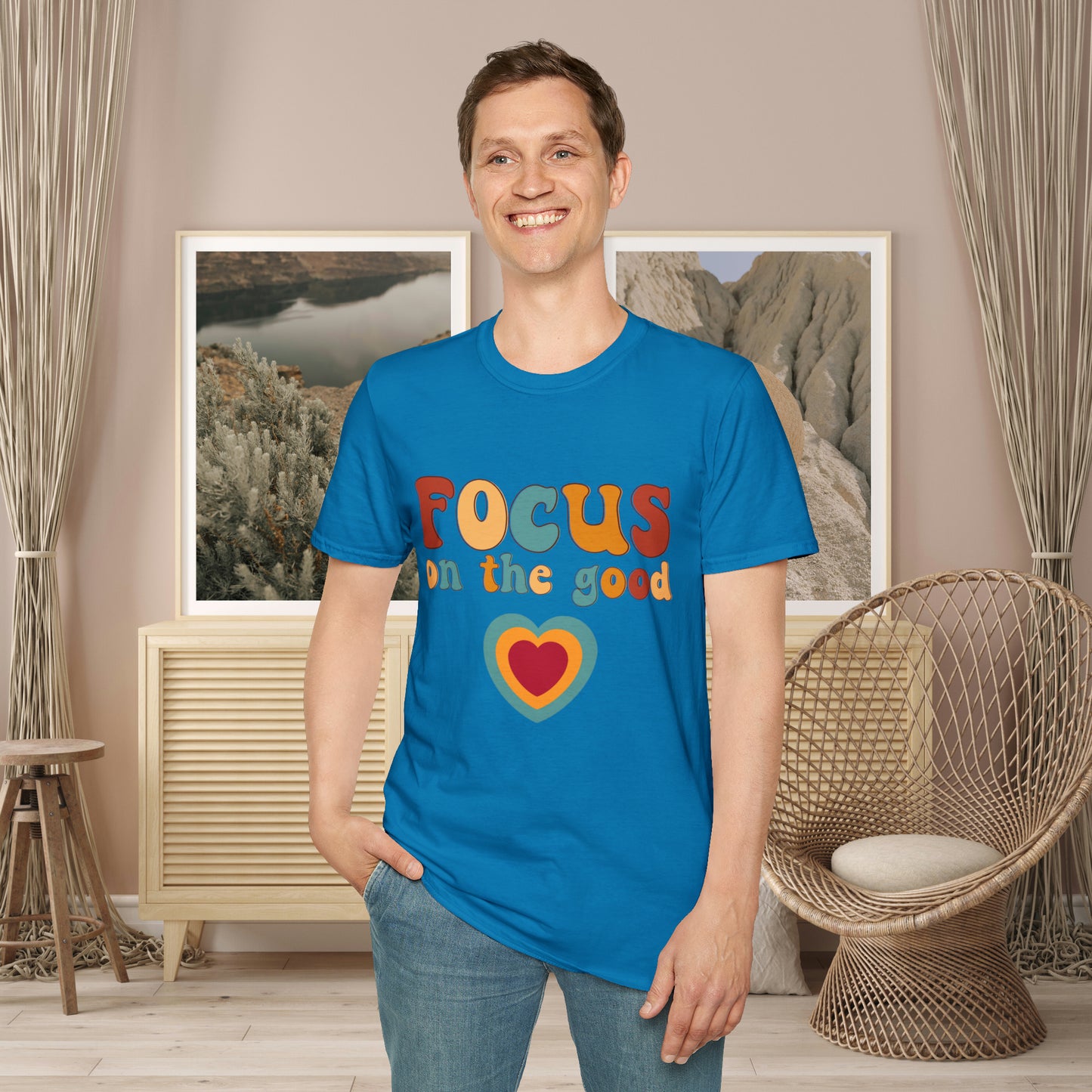 “FOCUS on the good” above a multicolored heart on this Unisex Softstyle T-Shirt.
