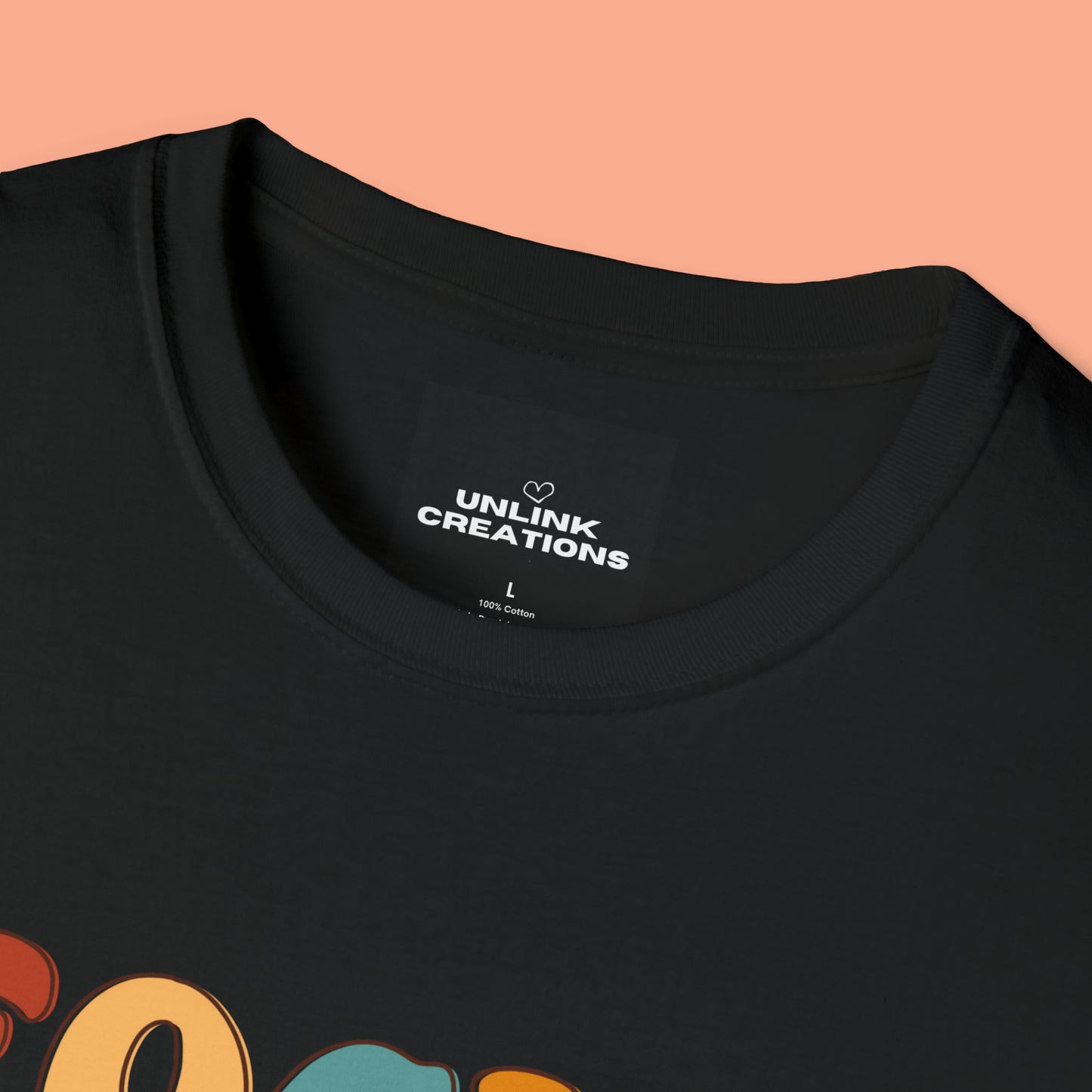 “FOCUS on the good” above a multicolored heart on this Unisex Softstyle T-Shirt.
