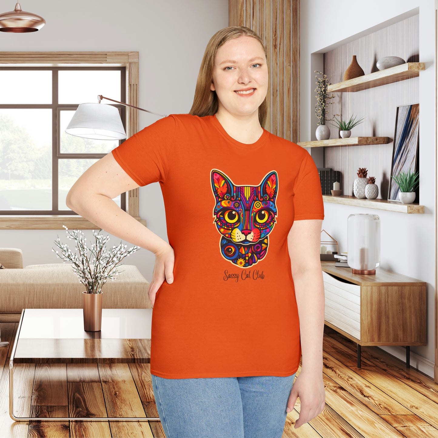 A mesmerizing cat that just pulls you to look into its eyes with “Sassy Cat Club” below it on this Unisex Softstyle T-Shirt.