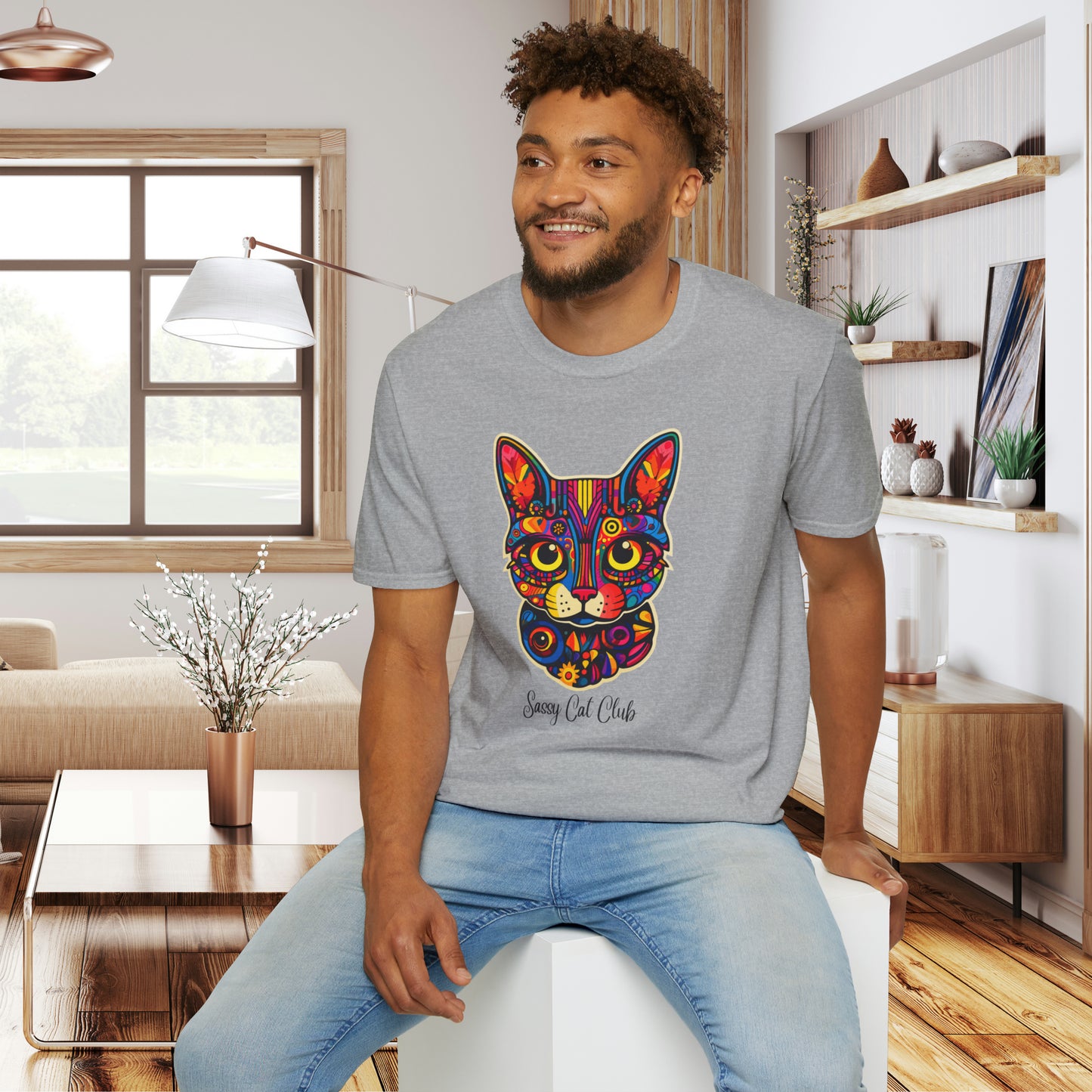 A mesmerizing cat that just pulls you to look into its eyes with “Sassy Cat Club” below it on this Unisex Softstyle T-Shirt.