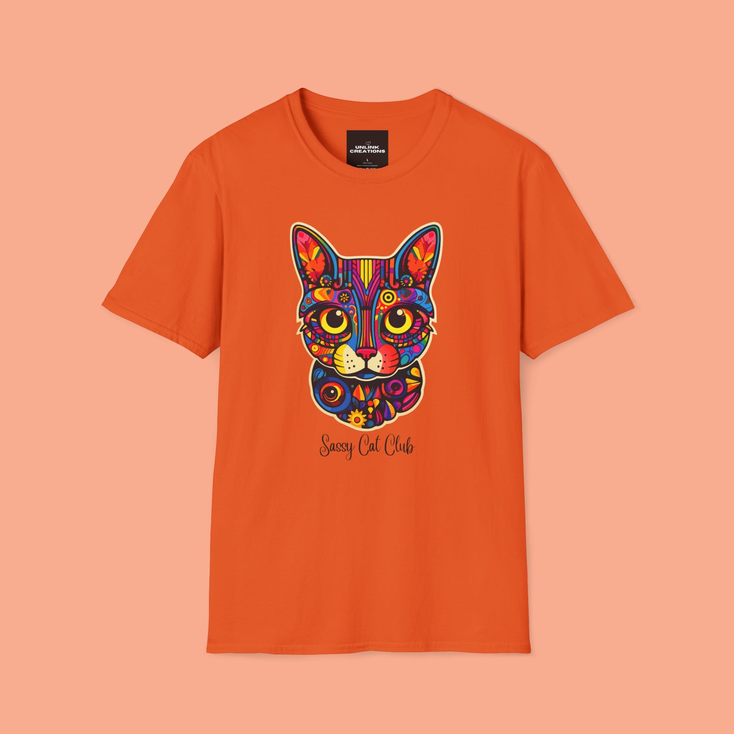 A mesmerizing cat that just pulls you to look into its eyes with “Sassy Cat Club” below it on this Unisex Softstyle T-Shirt.
