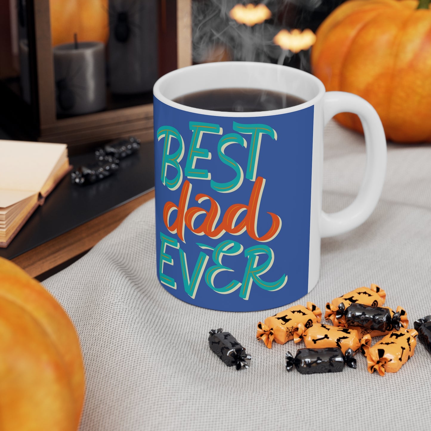 “BEST DAD EVER” on one side and dad reading to his baby. Part of several mugs to choose from depending on what resonates with you.