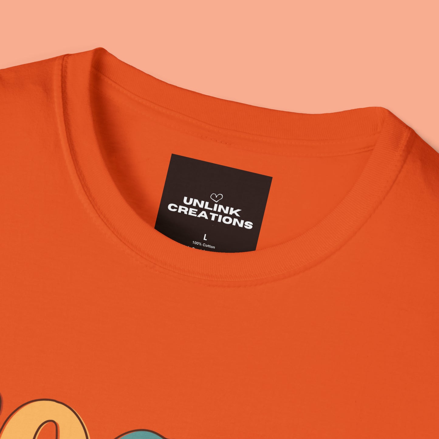 “FOCUS on the good” above a multicolored heart on this Unisex Softstyle T-Shirt.