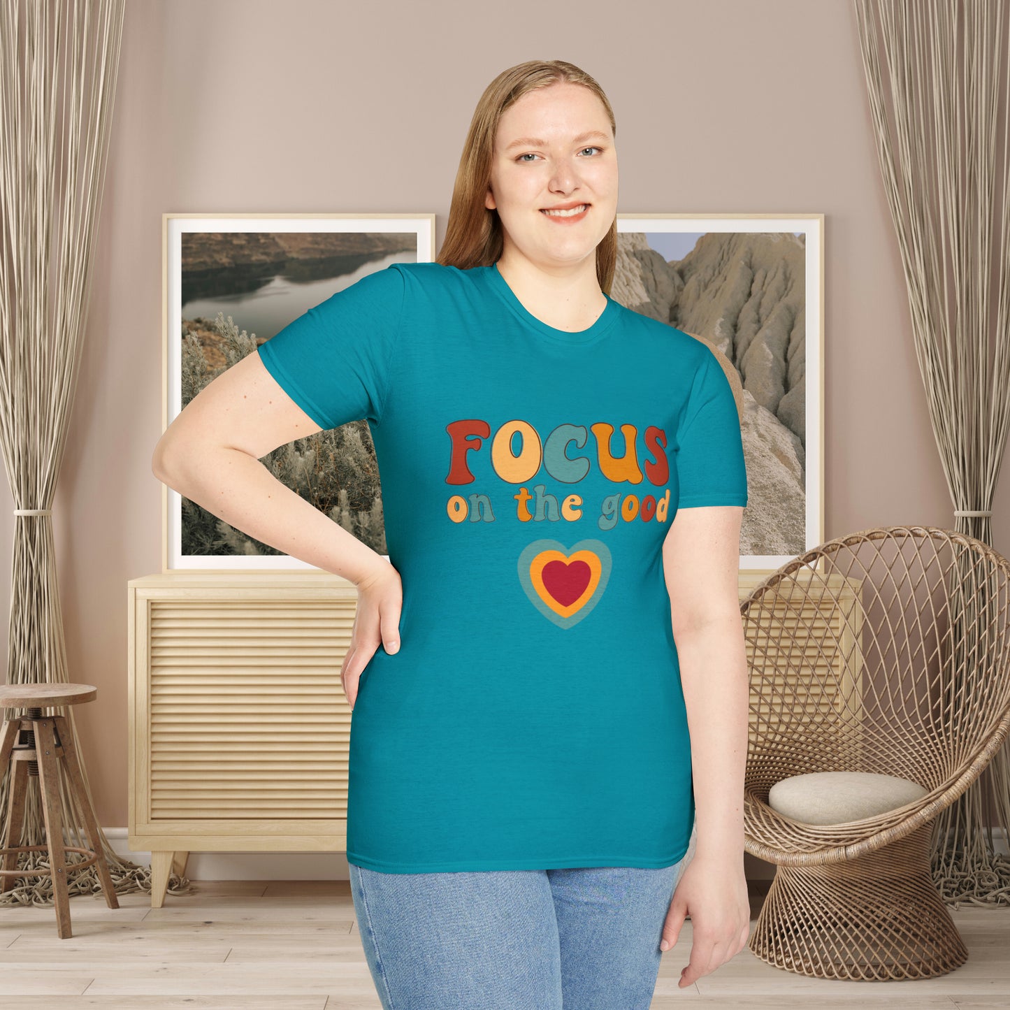 “FOCUS on the good” above a multicolored heart on this Unisex Softstyle T-Shirt.