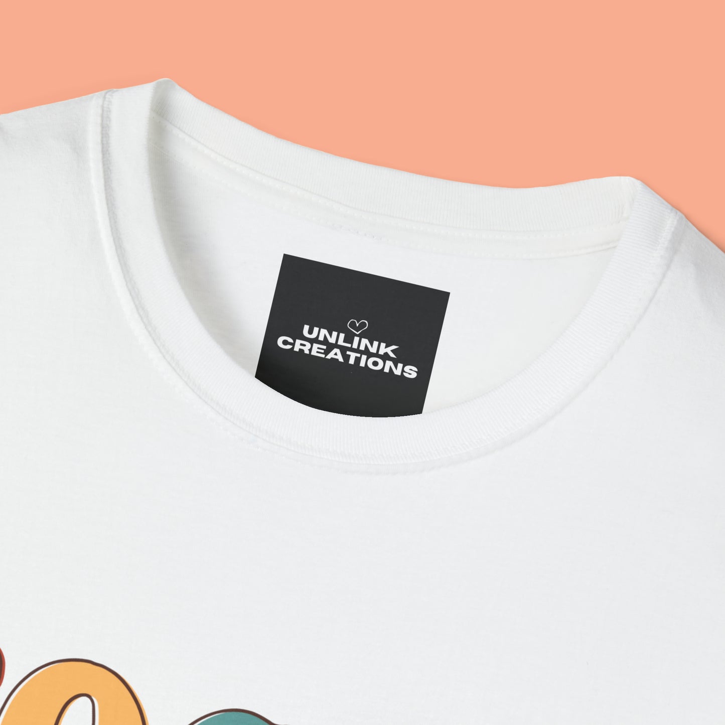 “FOCUS on the good” above a multicolored heart on this Unisex Softstyle T-Shirt.