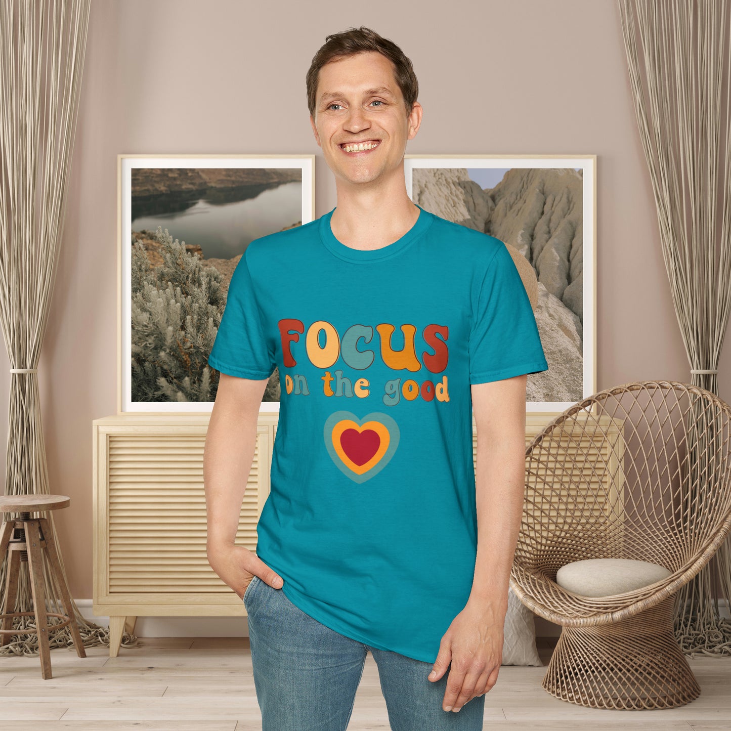 “FOCUS on the good” above a multicolored heart on this Unisex Softstyle T-Shirt.