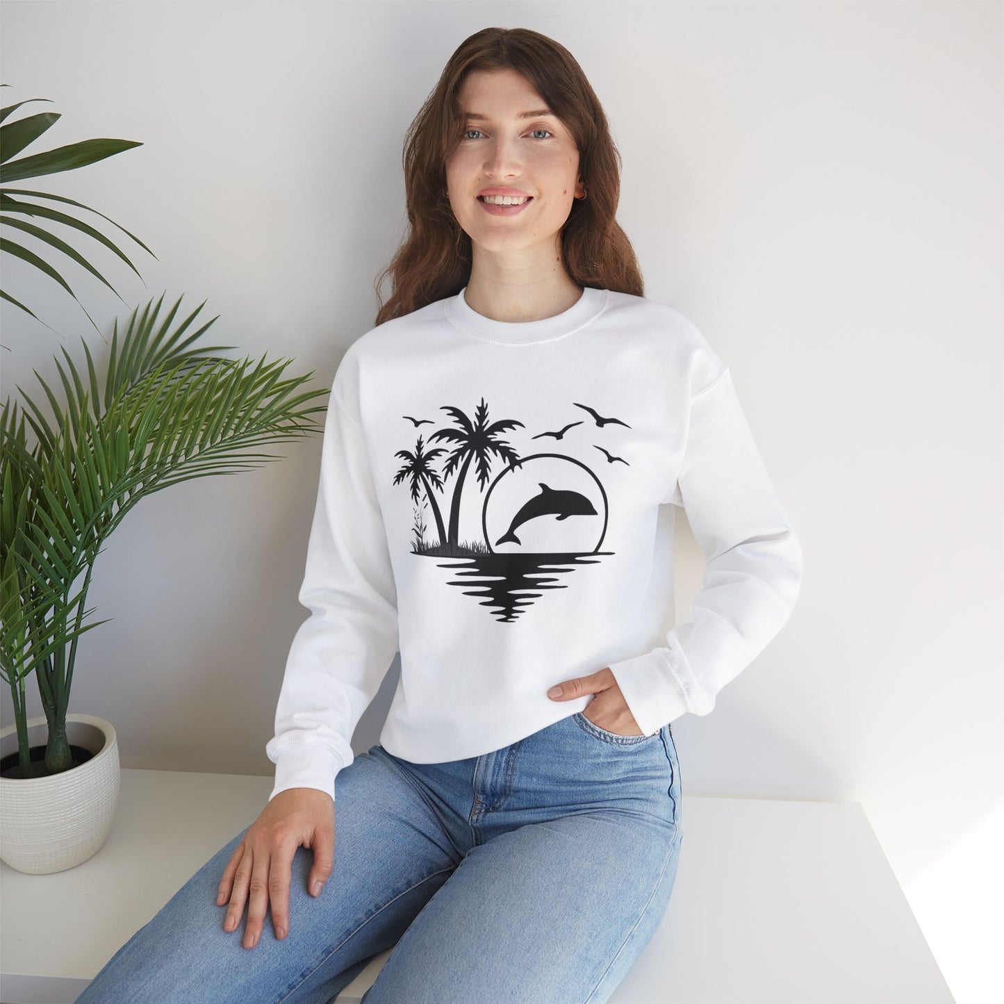 Silhouettes of palm trees, playful dolphin, and the ocean water make this cozy sweatshirt. Give the gift of this Unisex Heavy Blend™ Crewneck Sweatshirt or get one for yourself.