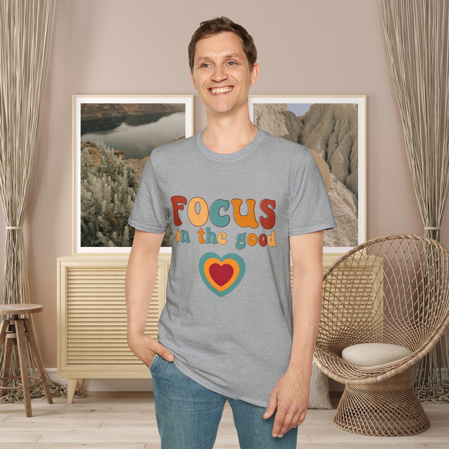 “FOCUS on the good” above a multicolored heart on this Unisex Softstyle T-Shirt.