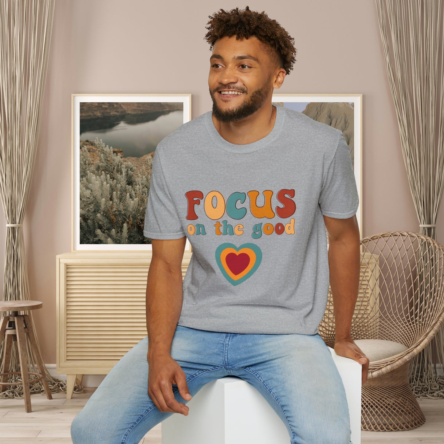 “FOCUS on the good” above a multicolored heart on this Unisex Softstyle T-Shirt.