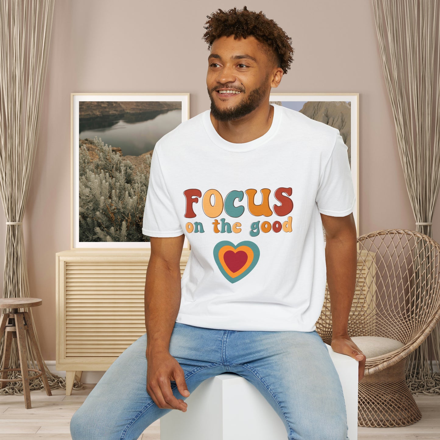 “FOCUS on the good” above a multicolored heart on this Unisex Softstyle T-Shirt.