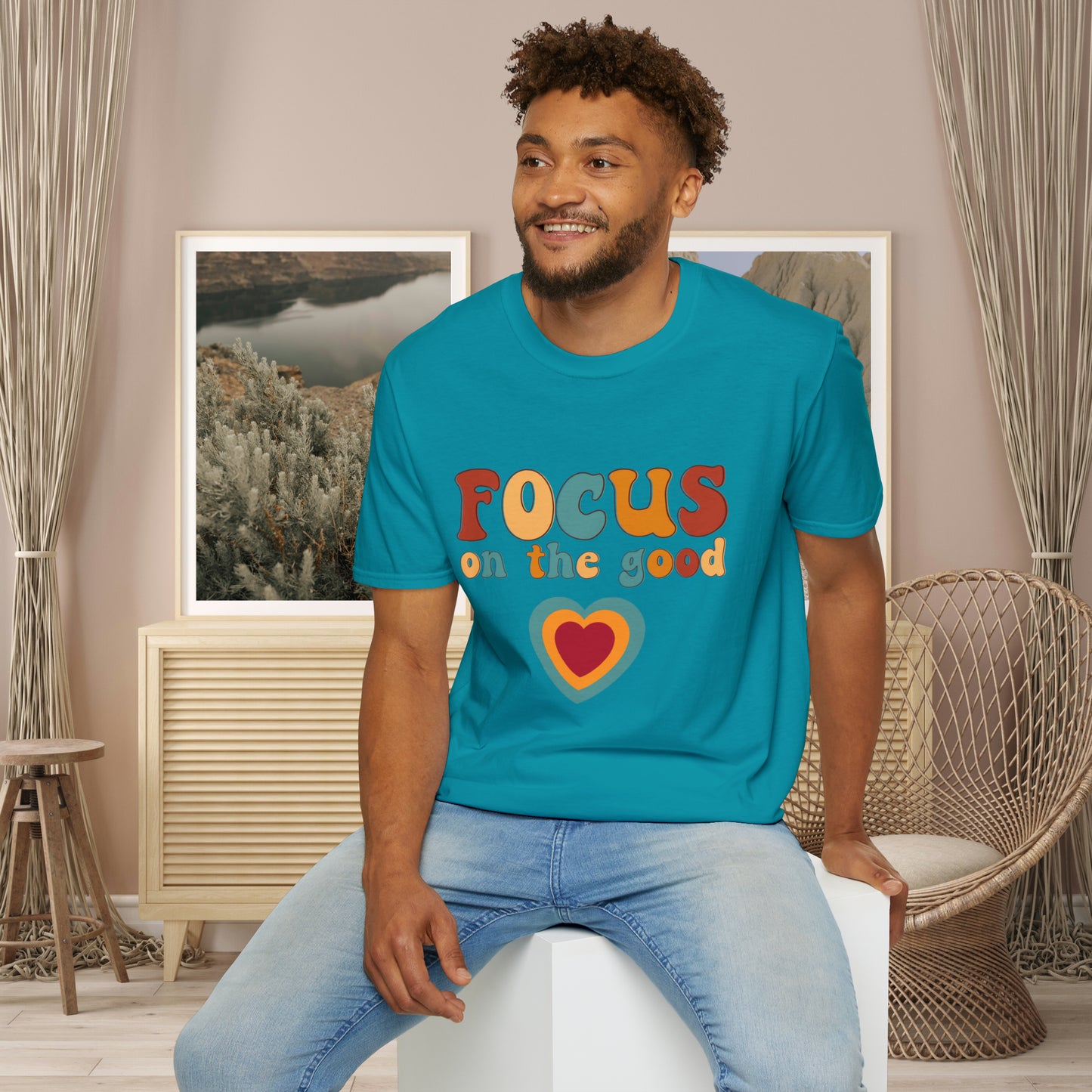 “FOCUS on the good” above a multicolored heart on this Unisex Softstyle T-Shirt.