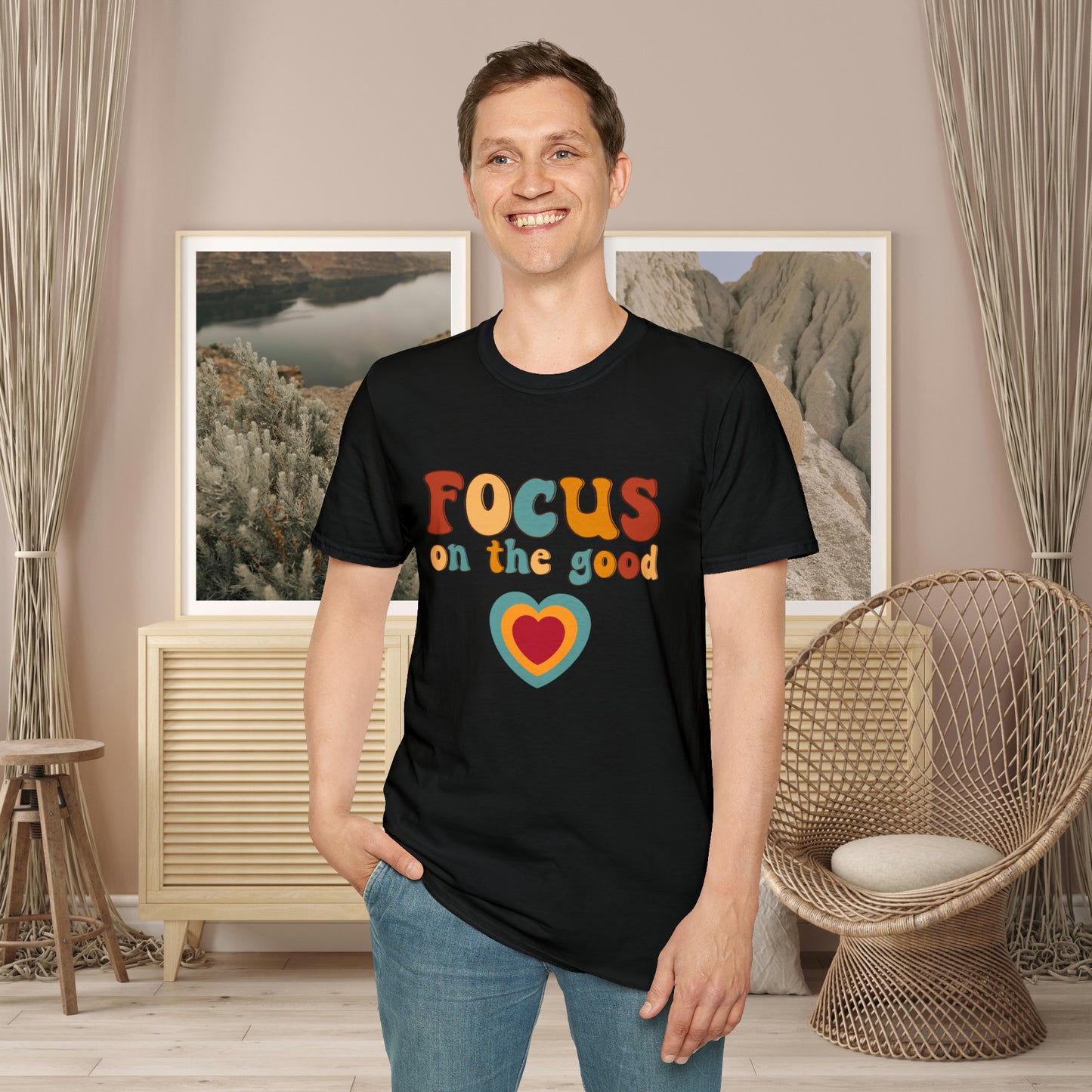 “FOCUS on the good” above a multicolored heart on this Unisex Softstyle T-Shirt.