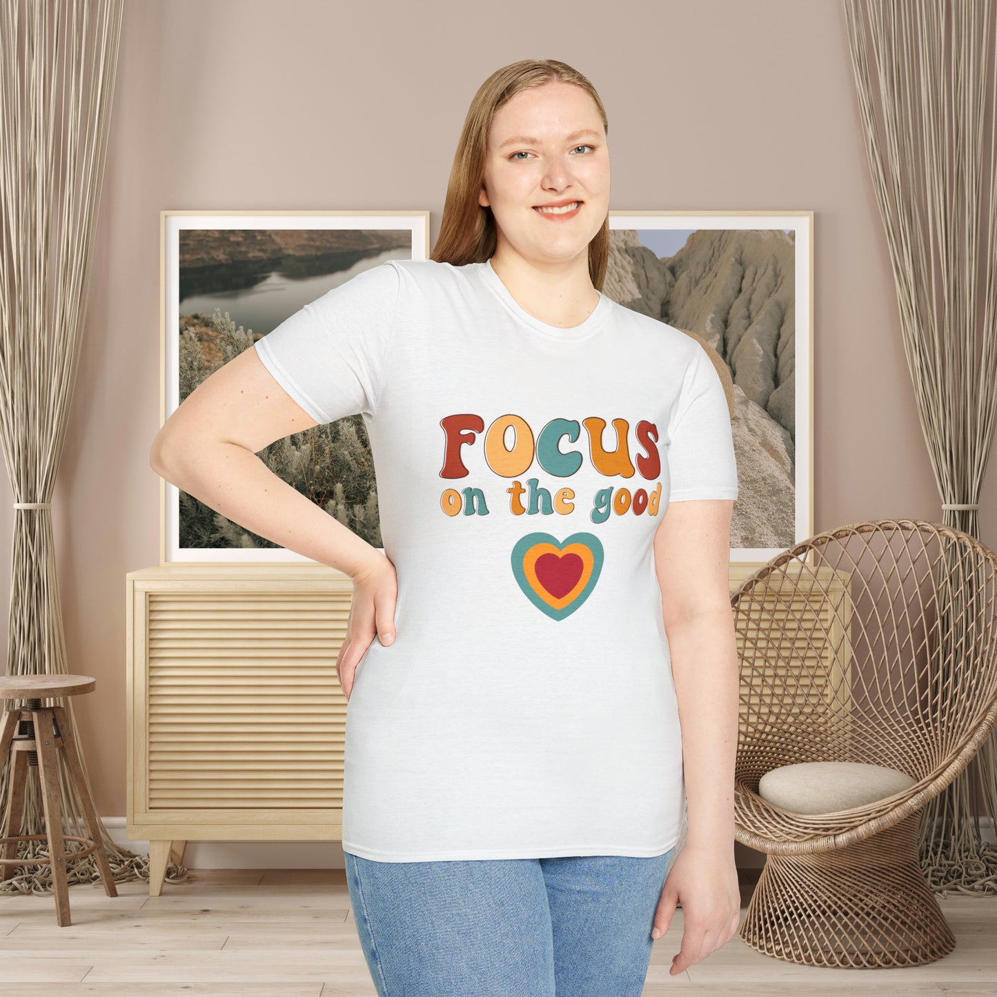 “FOCUS on the good” above a multicolored heart on this Unisex Softstyle T-Shirt.