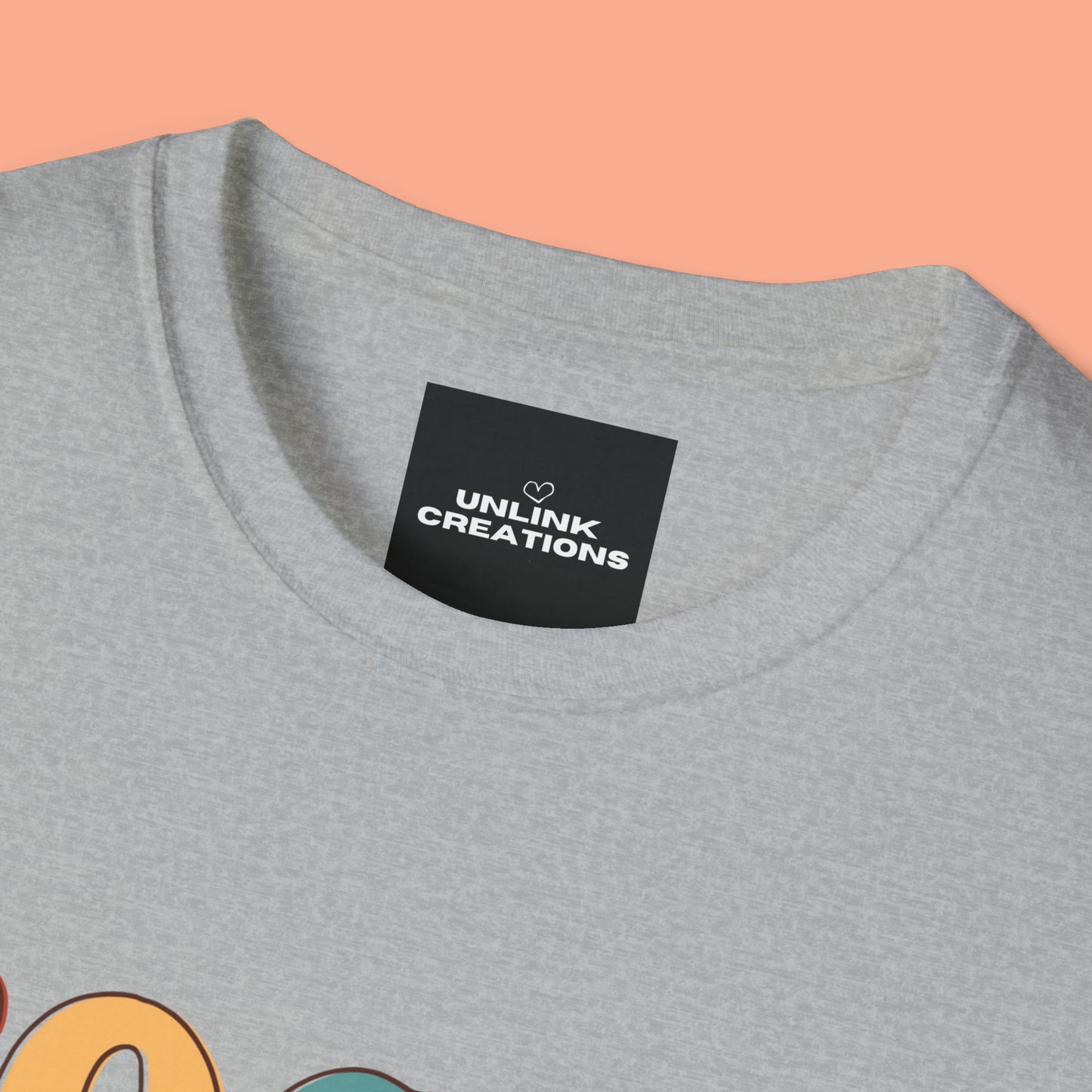 “FOCUS on the good” above a multicolored heart on this Unisex Softstyle T-Shirt.