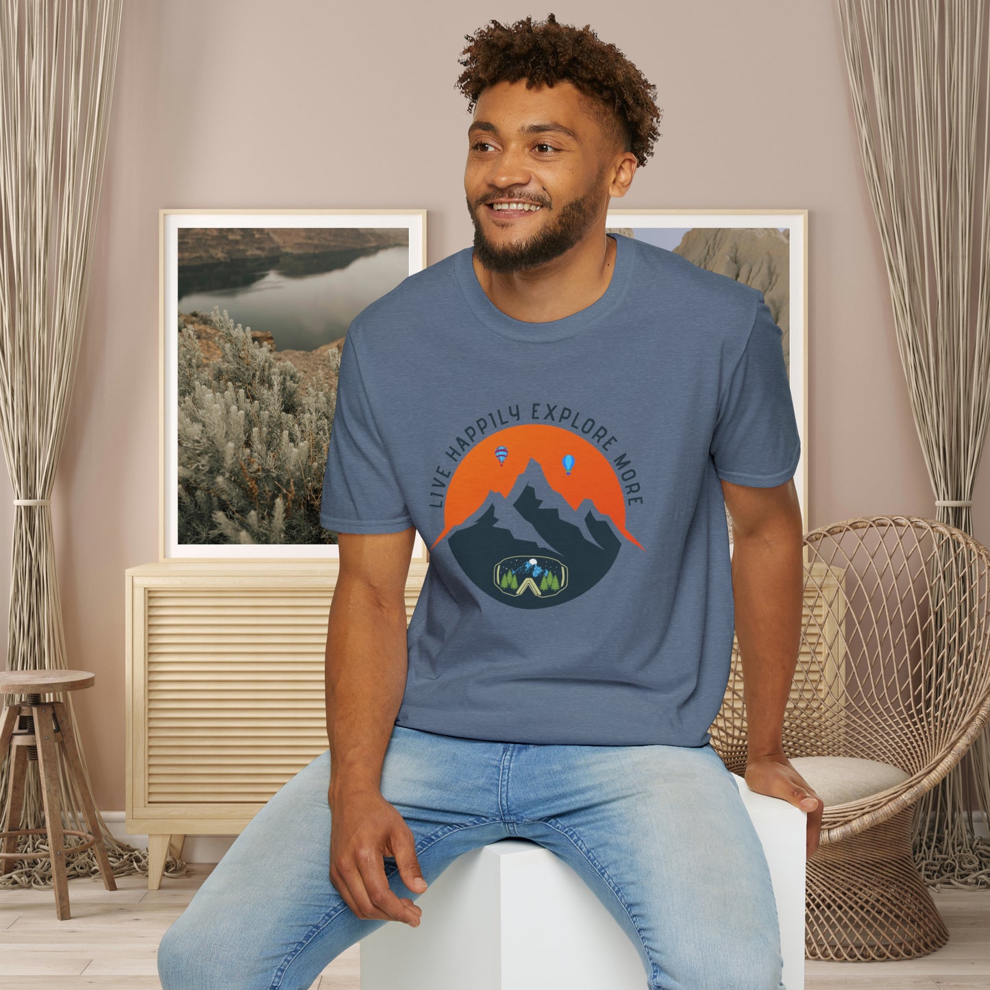 “LIVE HAPPILY EXPLORE MORE” message on this mountain sports inspired Unisex Softstyle T-Shirt.