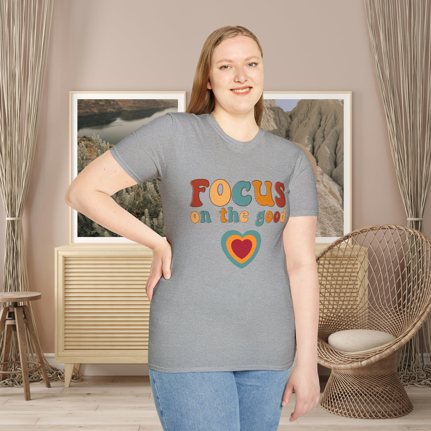 “FOCUS on the good” above a multicolored heart on this Unisex Softstyle T-Shirt.