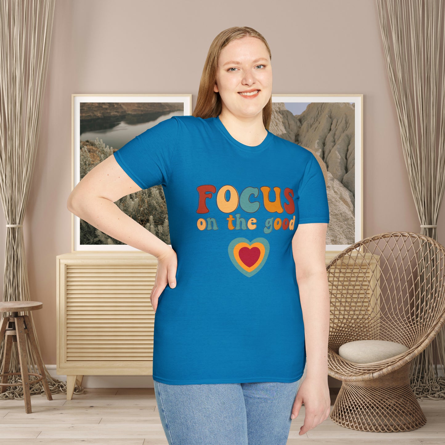 “FOCUS on the good” above a multicolored heart on this Unisex Softstyle T-Shirt.