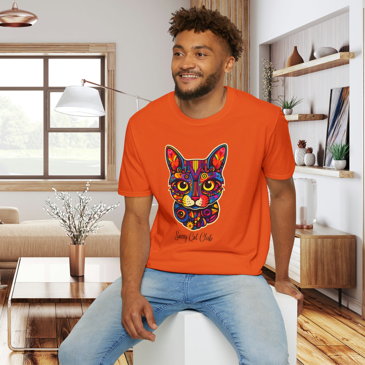 A mesmerizing cat that just pulls you to look into its eyes with “Sassy Cat Club” below it on this Unisex Softstyle T-Shirt.