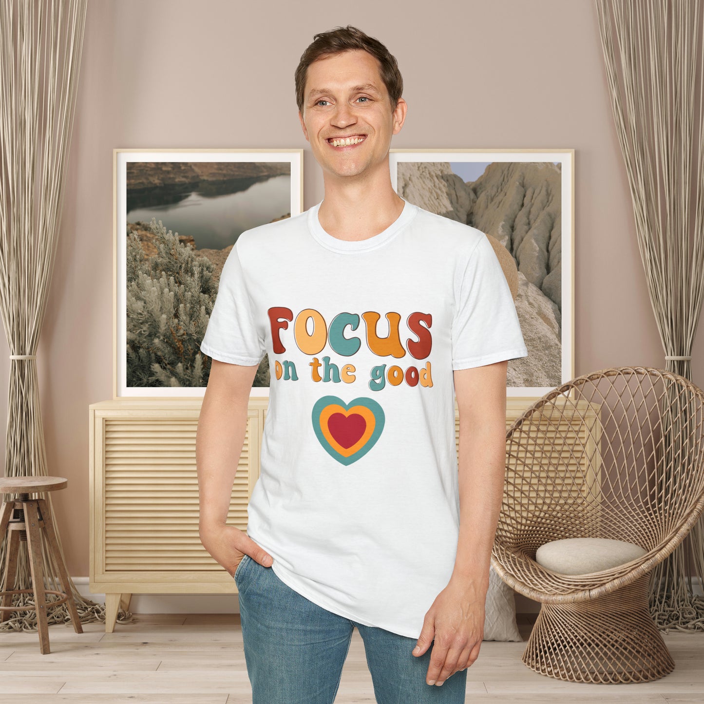“FOCUS on the good” above a multicolored heart on this Unisex Softstyle T-Shirt.