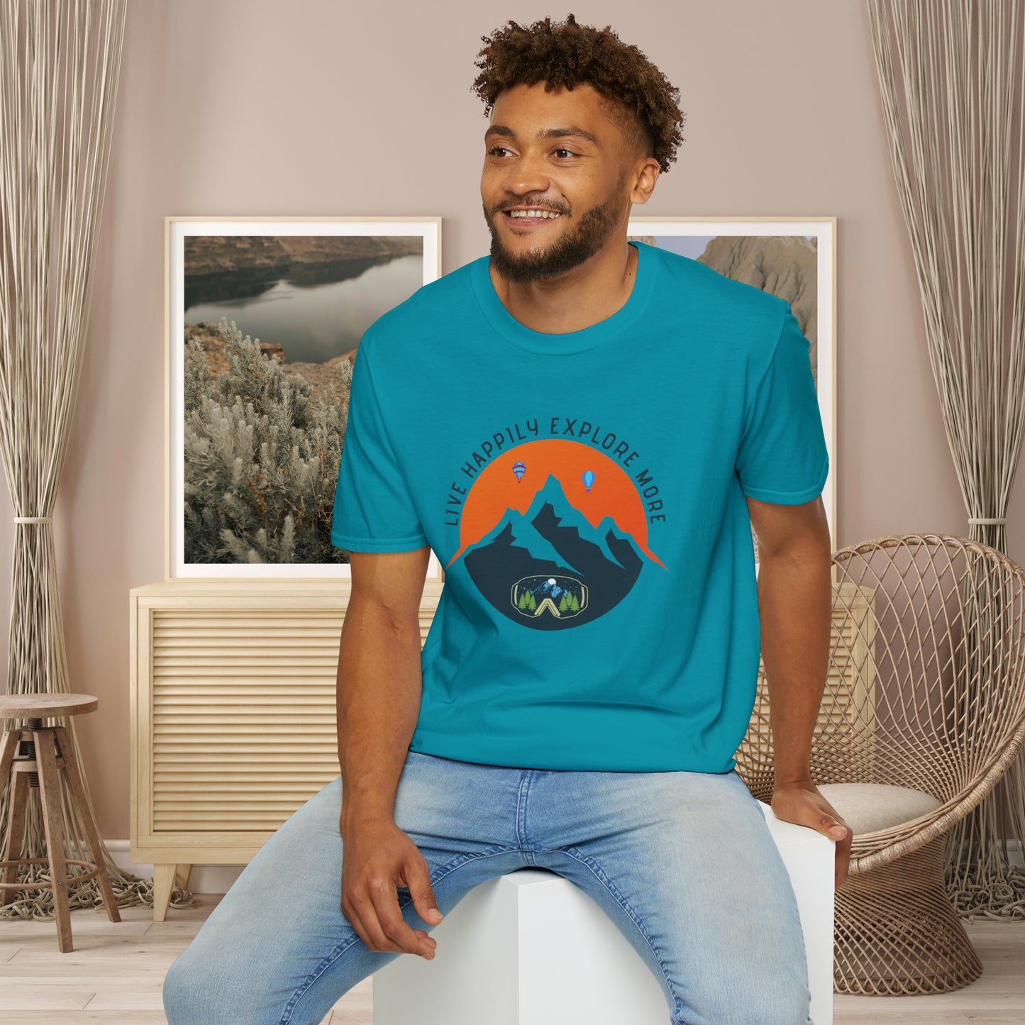 “LIVE HAPPILY EXPLORE MORE” message on this mountain sports inspired Unisex Softstyle T-Shirt.