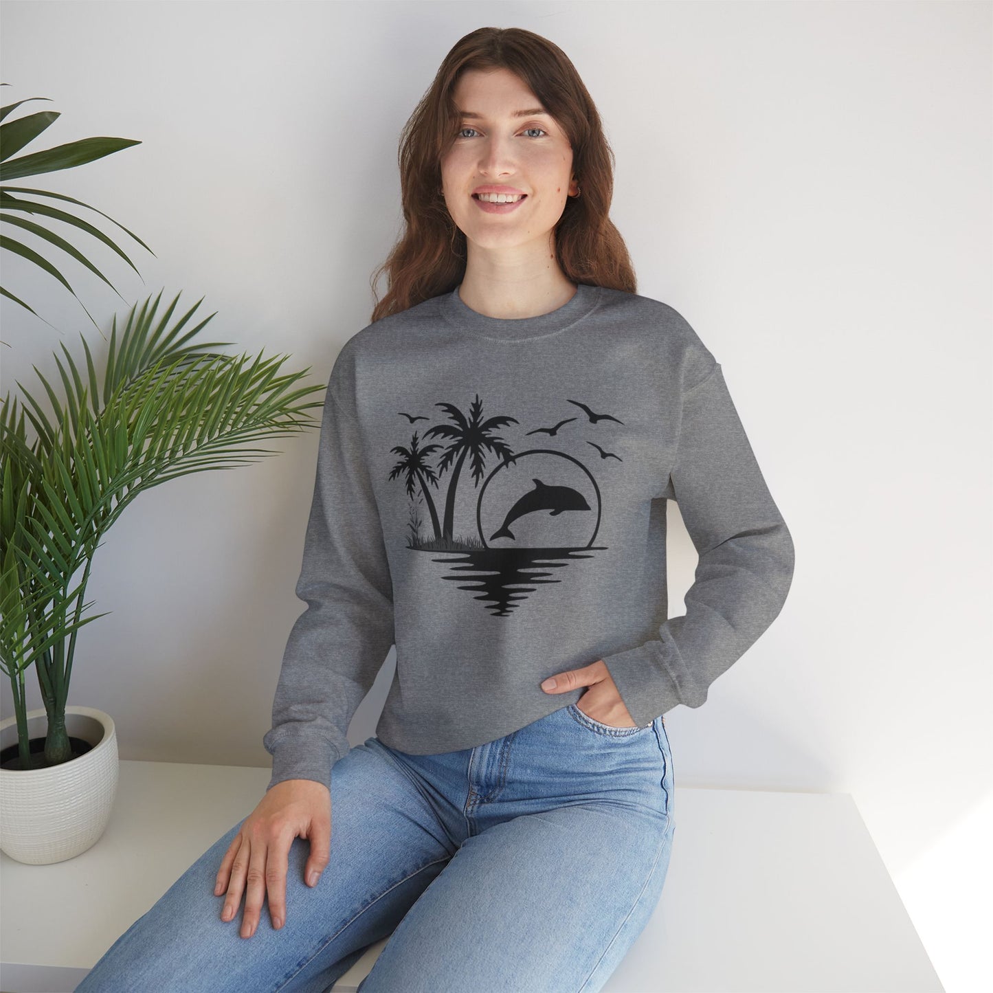 Silhouettes of palm trees, playful dolphin, and the ocean water make this cozy sweatshirt. Give the gift of this Unisex Heavy Blend™ Crewneck Sweatshirt or get one for yourself.