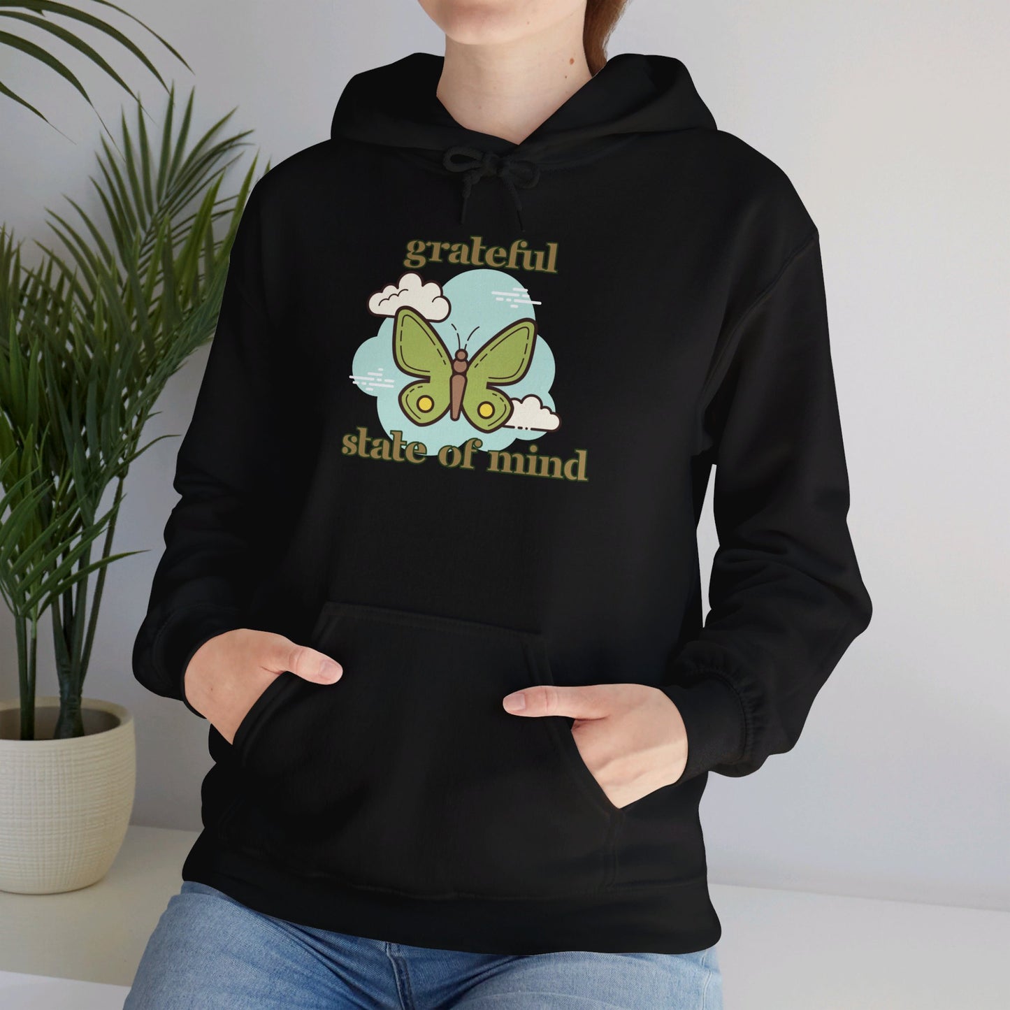 Grateful state of mind around a simple butterfly design on this Unisex Heavy Blend™ Hooded Sweatshirt