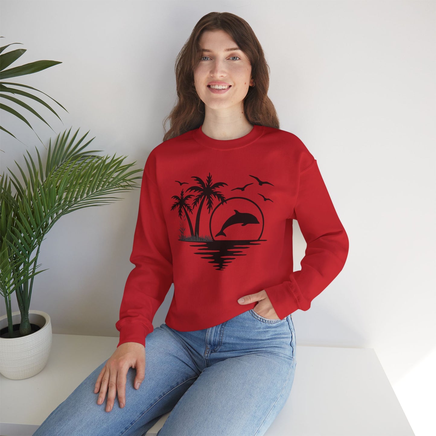 Silhouettes of palm trees, playful dolphin, and the ocean water make this cozy sweatshirt. Give the gift of this Unisex Heavy Blend™ Crewneck Sweatshirt or get one for yourself.