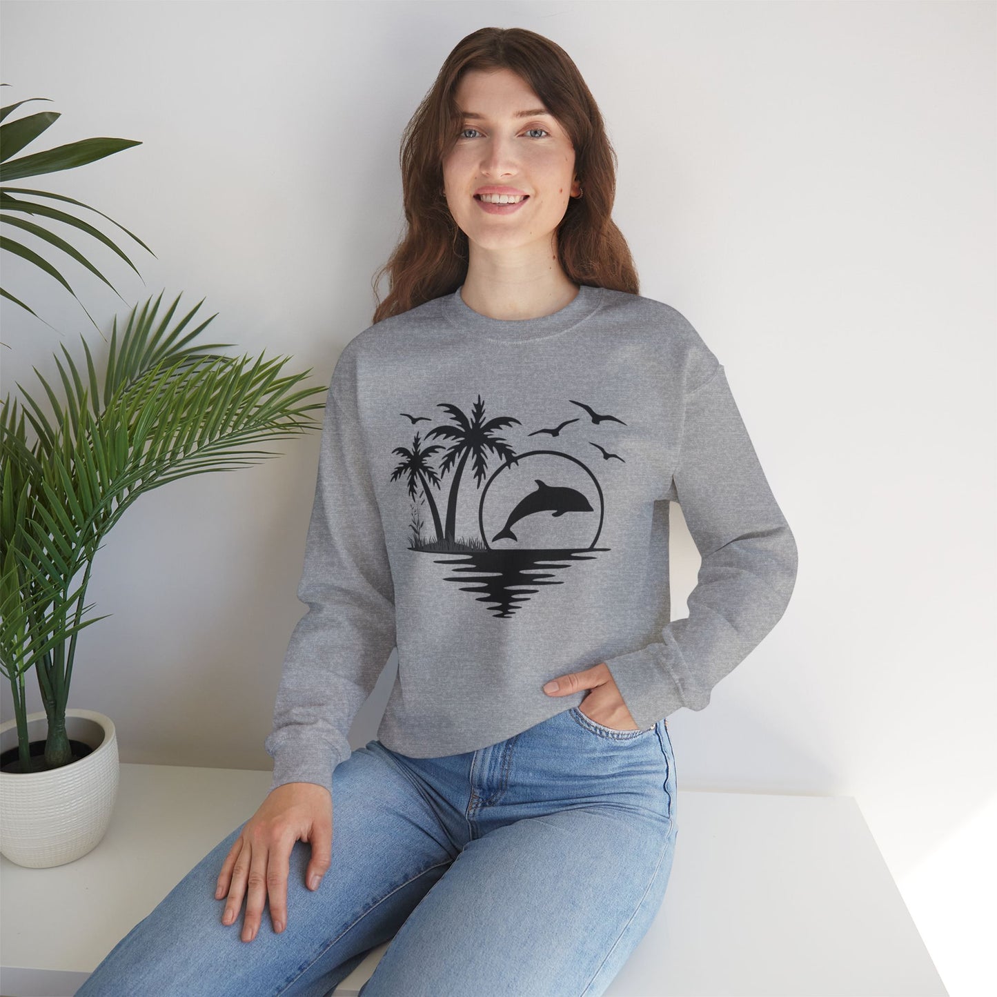 Silhouettes of palm trees, playful dolphin, and the ocean water make this cozy sweatshirt. Give the gift of this Unisex Heavy Blend™ Crewneck Sweatshirt or get one for yourself.