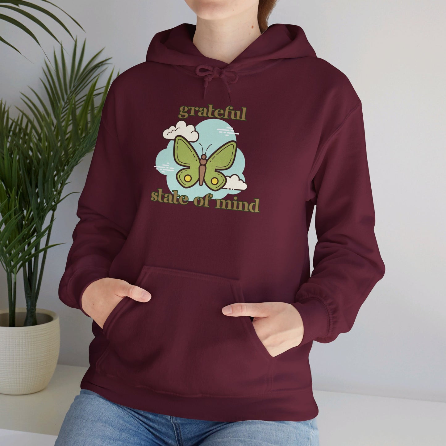 Grateful state of mind around a simple butterfly design on this Unisex Heavy Blend™ Hooded Sweatshirt