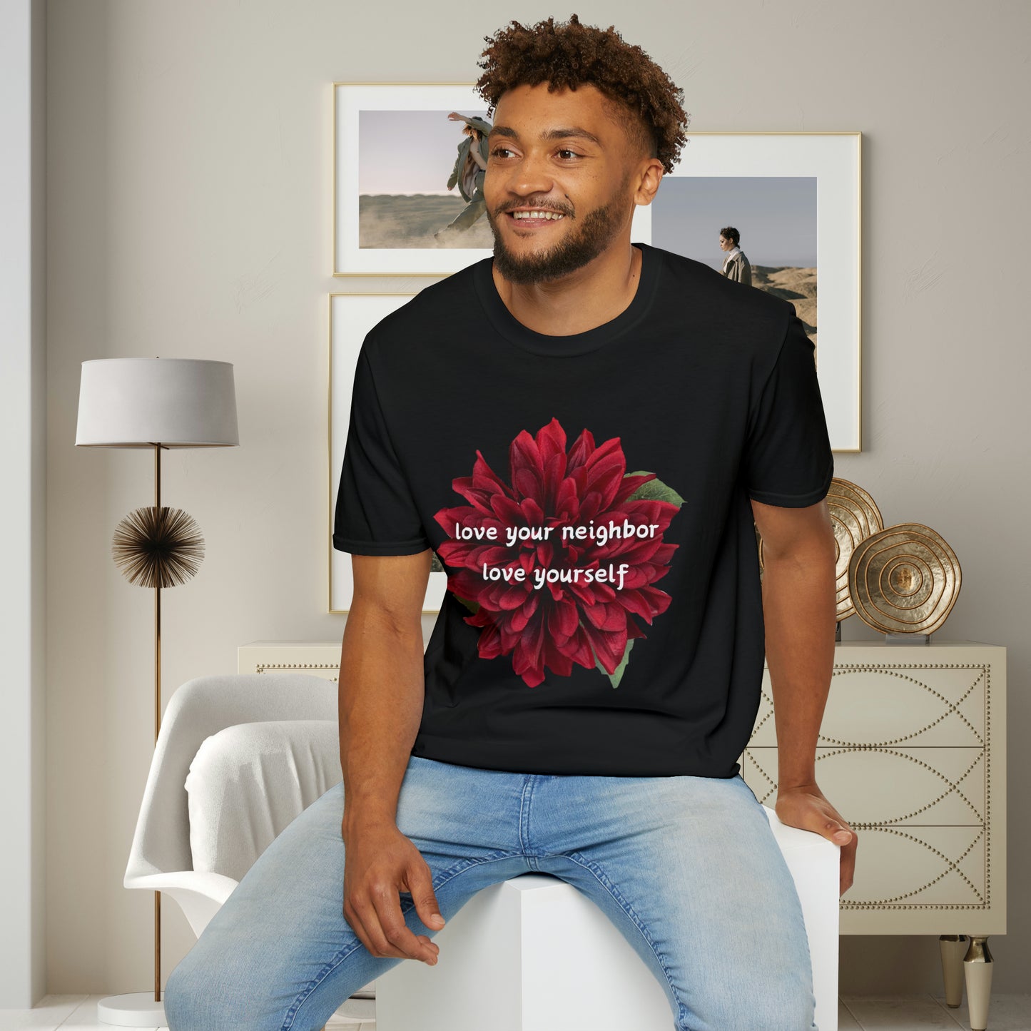 A message of “love your neighbor love yourself” over a beautiful red flower. This is a Unisex Softstyle T-Shirt.