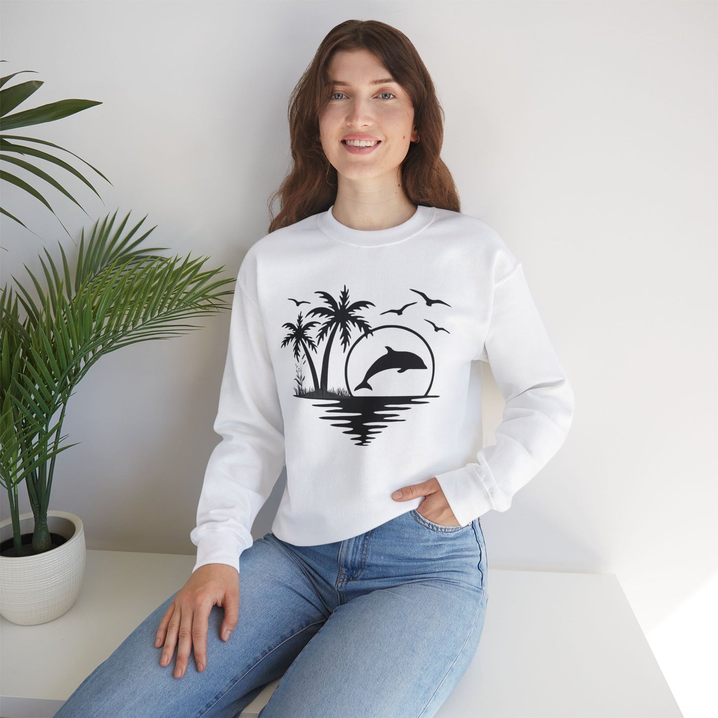 Silhouettes of palm trees, playful dolphin, and the ocean water make this cozy sweatshirt. Give the gift of this Unisex Heavy Blend™ Crewneck Sweatshirt or get one for yourself.