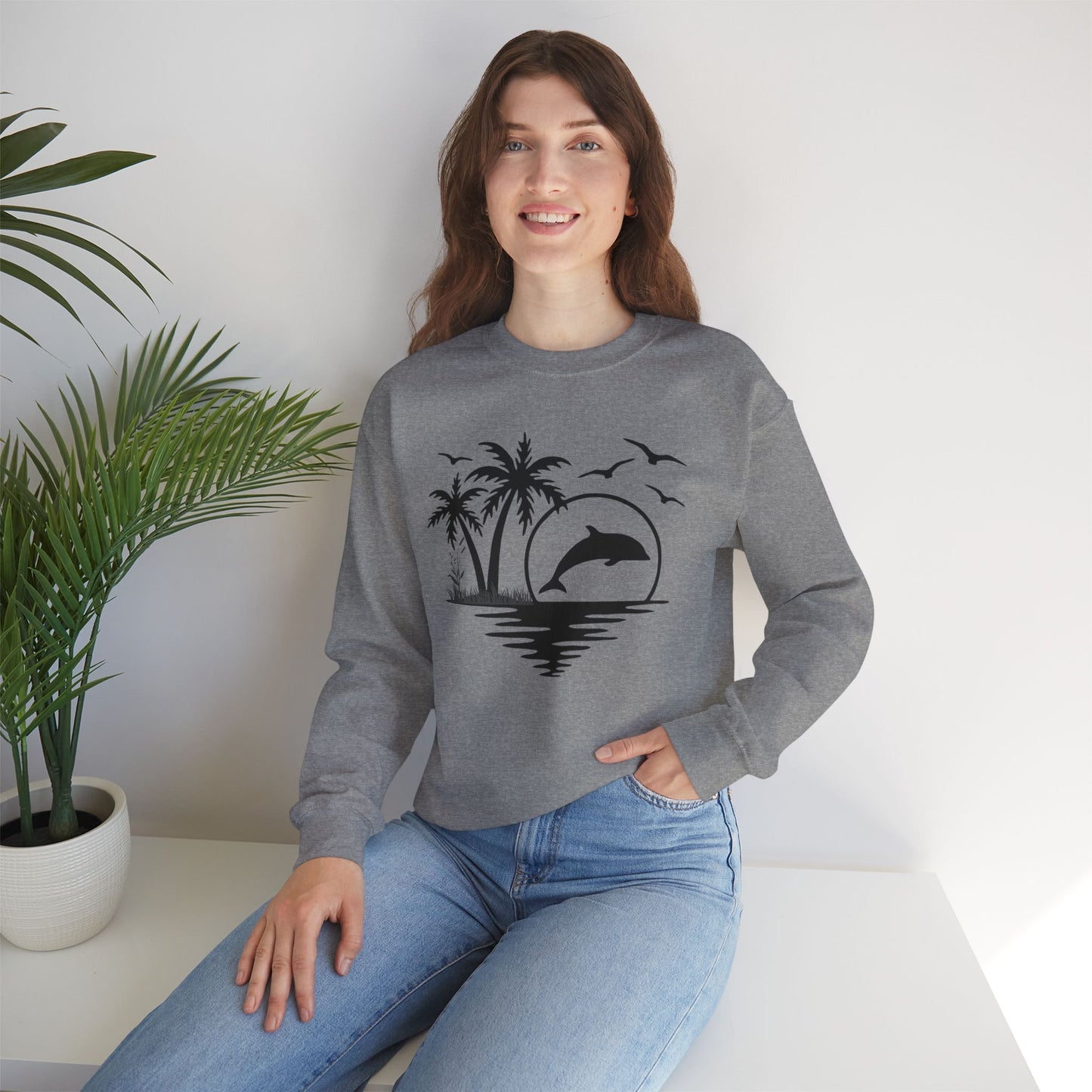 Silhouettes of palm trees, playful dolphin, and the ocean water make this cozy sweatshirt. Give the gift of this Unisex Heavy Blend™ Crewneck Sweatshirt or get one for yourself.